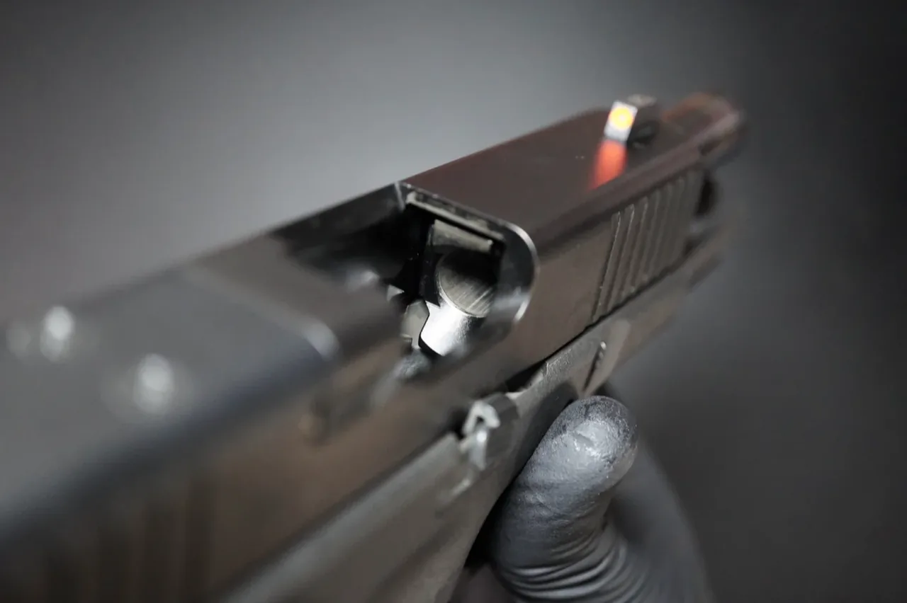 Looking down into the empty chamber of a Glock 19 with the slide locked open