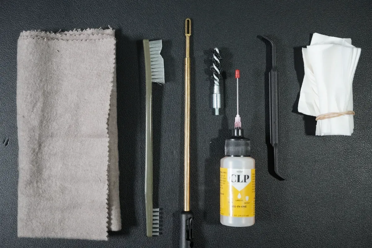 P365 cleaning supplies laid out: rag, brushes, cleaning rod, bore brush, CLP, pick, and patches