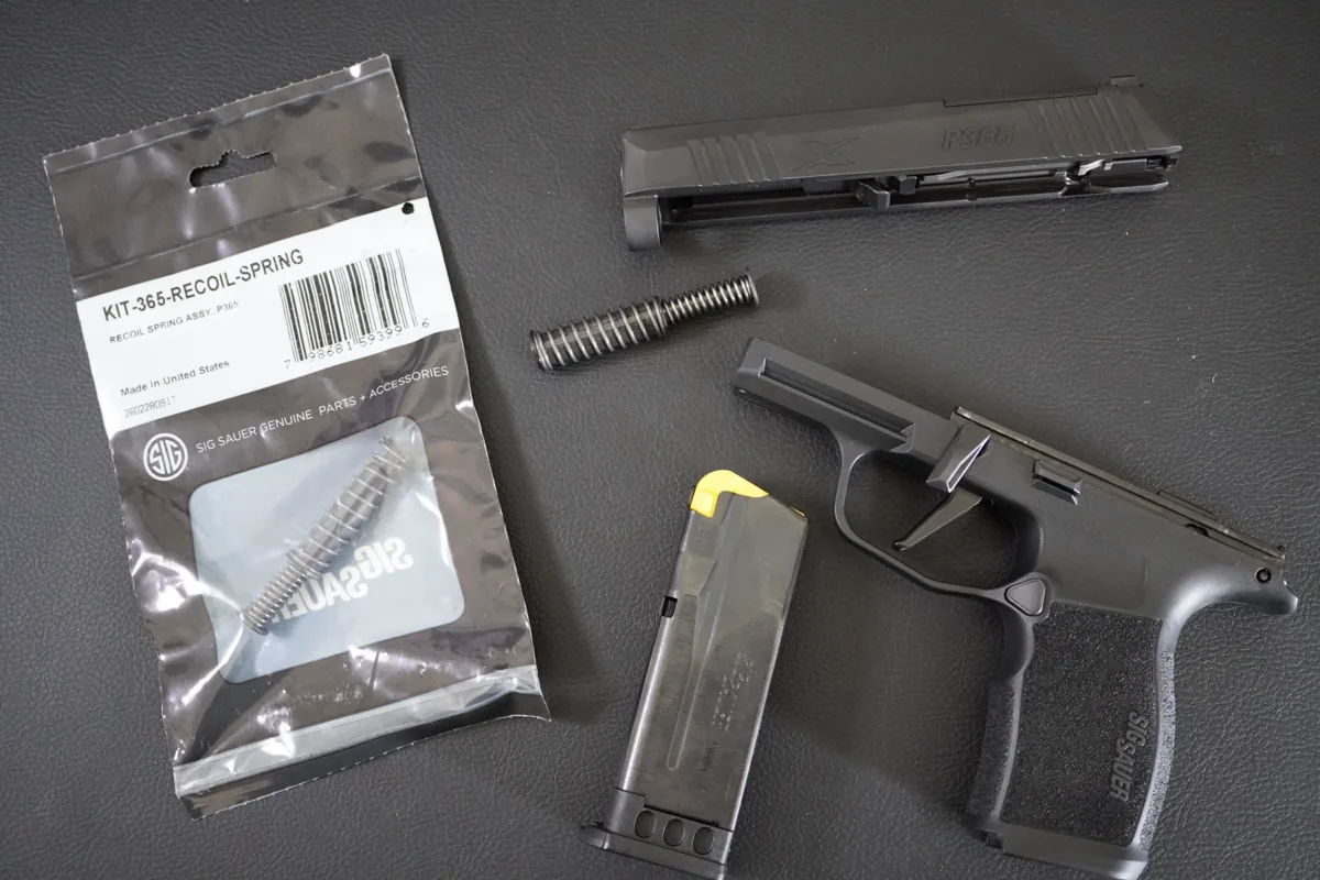 SIG P365 recoil spring assembly (KIT-365-RECOIL-SPRING) next to a field-stripped P365X slide, frame, and magazine